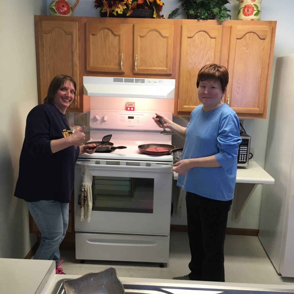 Donna and Karen working the stove.