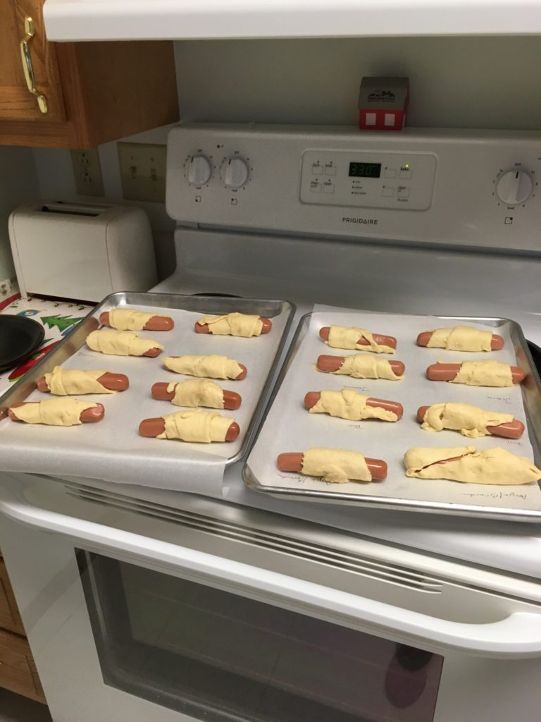 Pigs in a Blanket on a stove top.